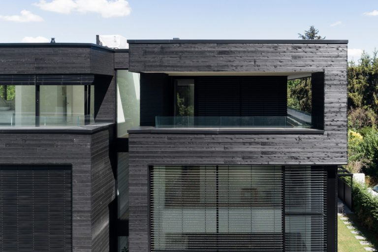 Semidetached house with black facade wood