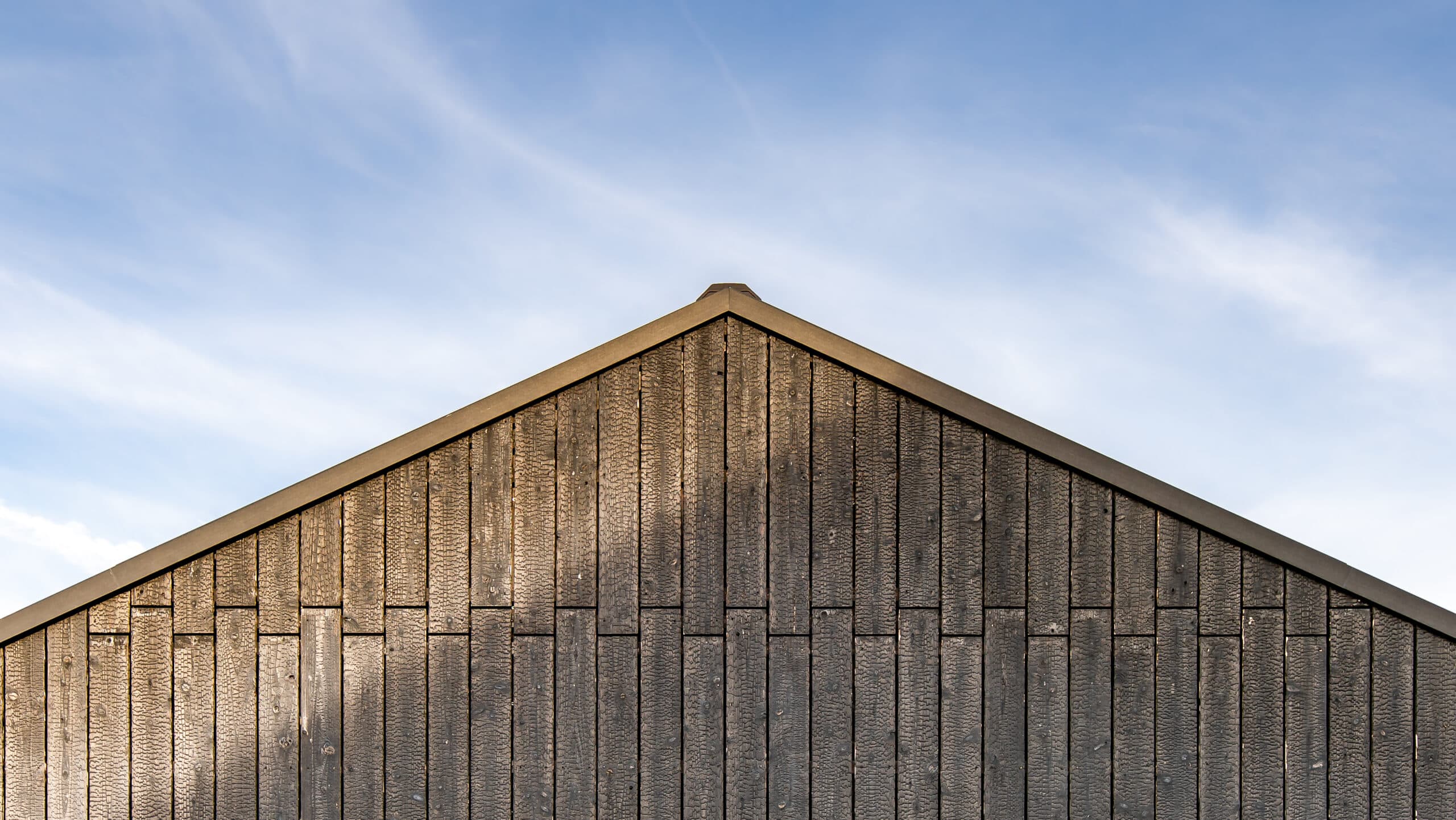 Black wooden boards laid individually on a house facade