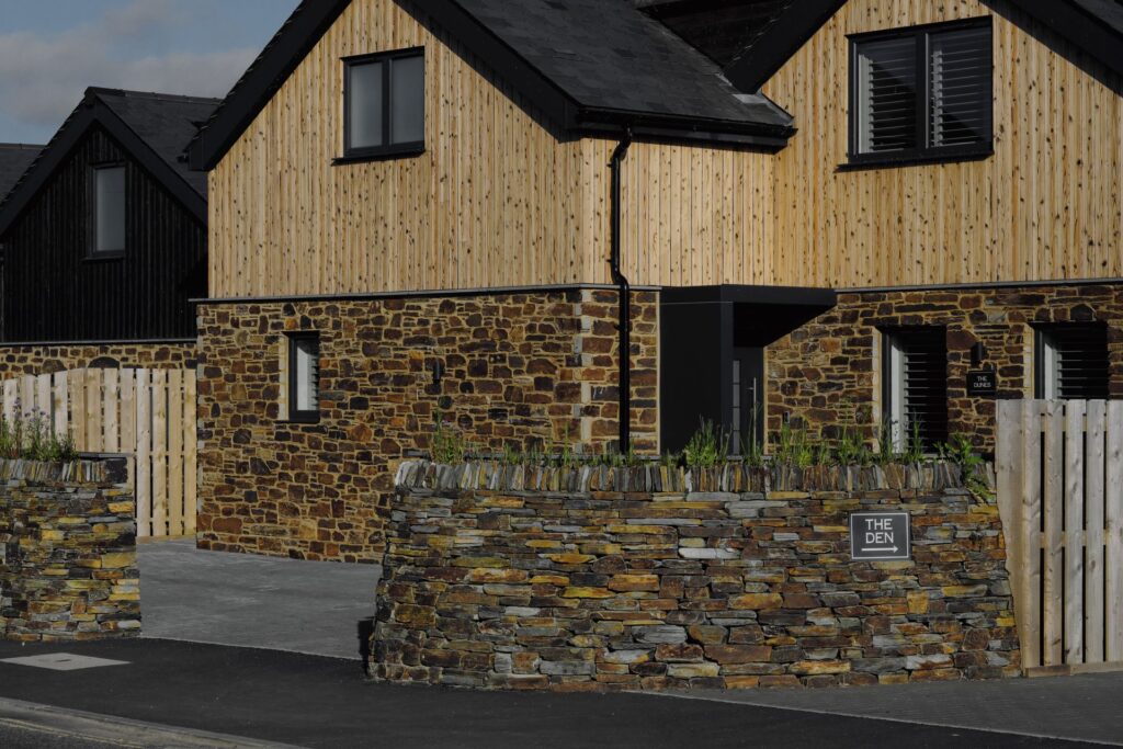 Yakisugi-clad Leverlake houses with stone wall